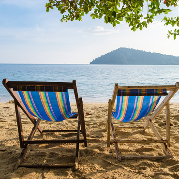 Wooden Beach chairs on a tropical beach at Klong Kloi Beach Koh Chang Thailand